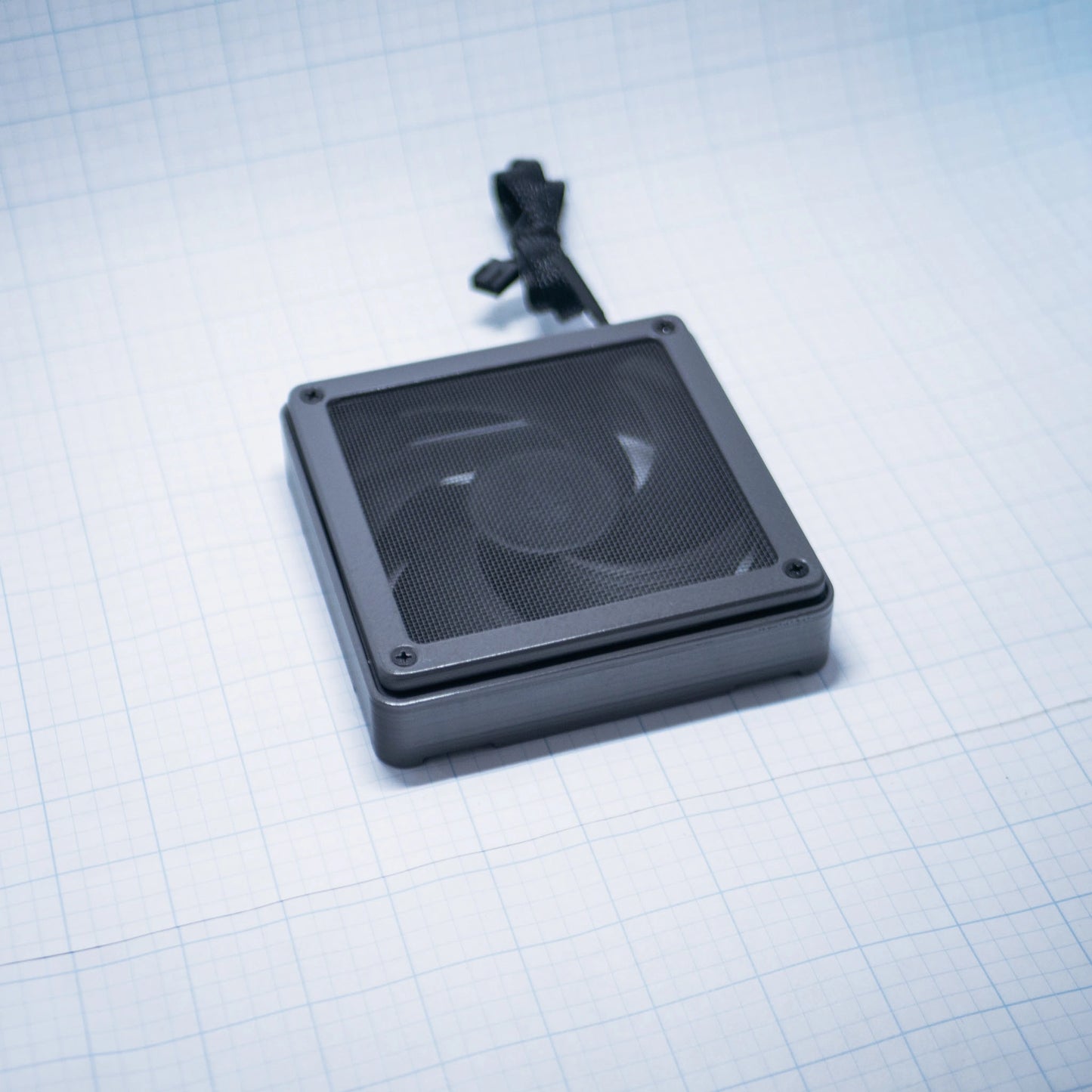 Charcoal Gray shell with charcoal gray mesh - 120mm Fan Shroud Filter & Outer Cover lying flat against white background with grid pattern. 