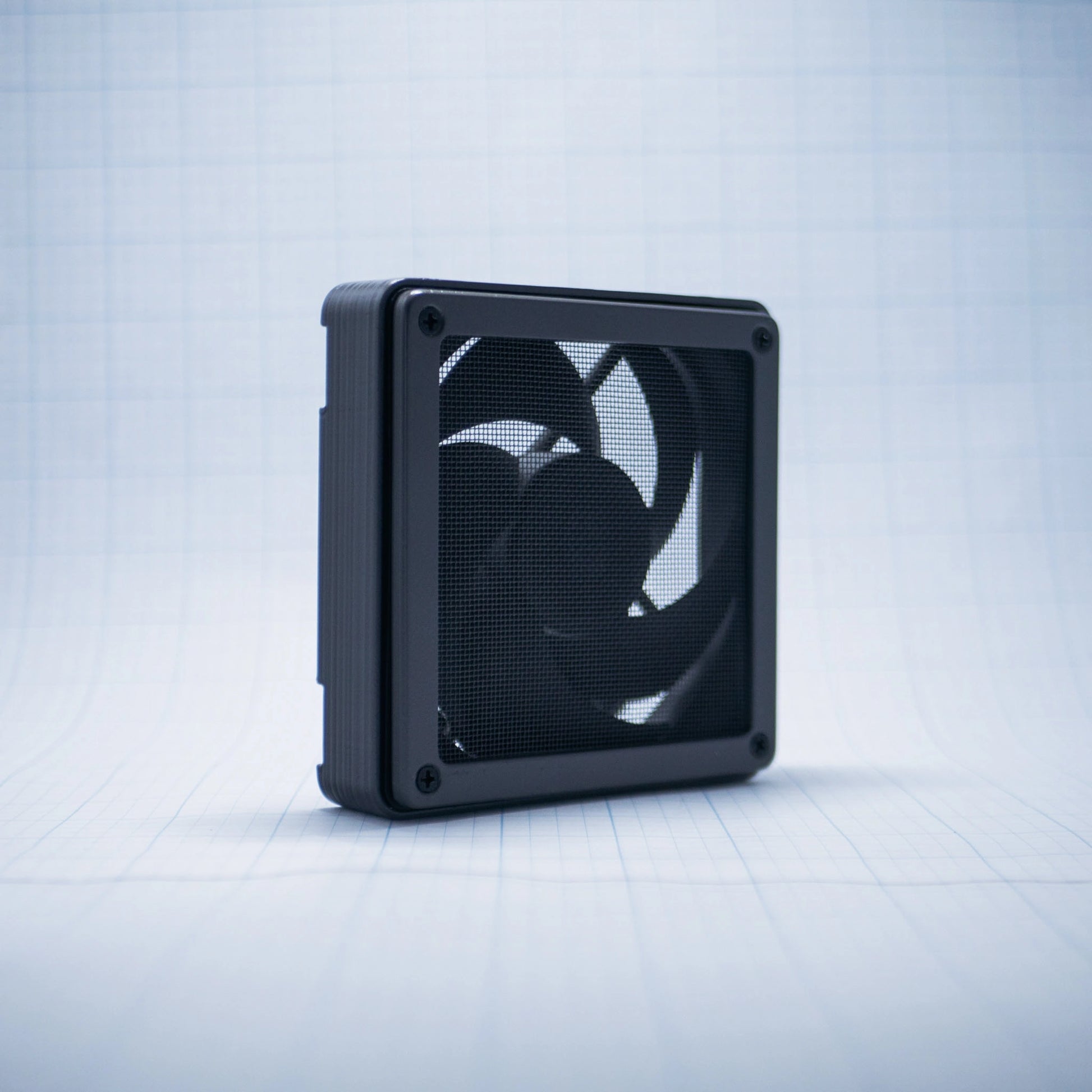Charcoal gray with Charcoal gray 120mm Fan Shroud Filter & Outer Cover with an angled front view against white background with grid pattern. 